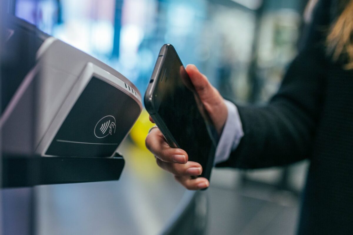 Person's hand making a contactless payment with their smartphone